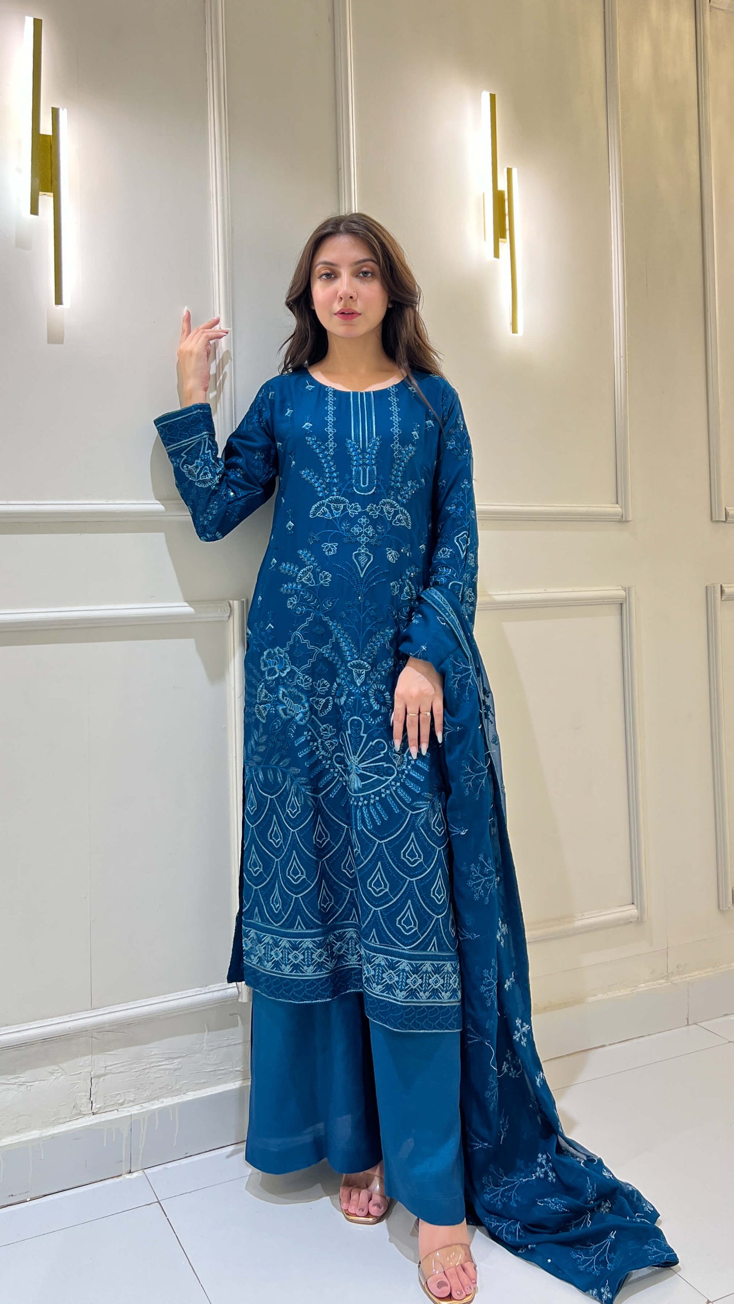 Woman in wearing peacock blue embroidered festive 3 piece suit