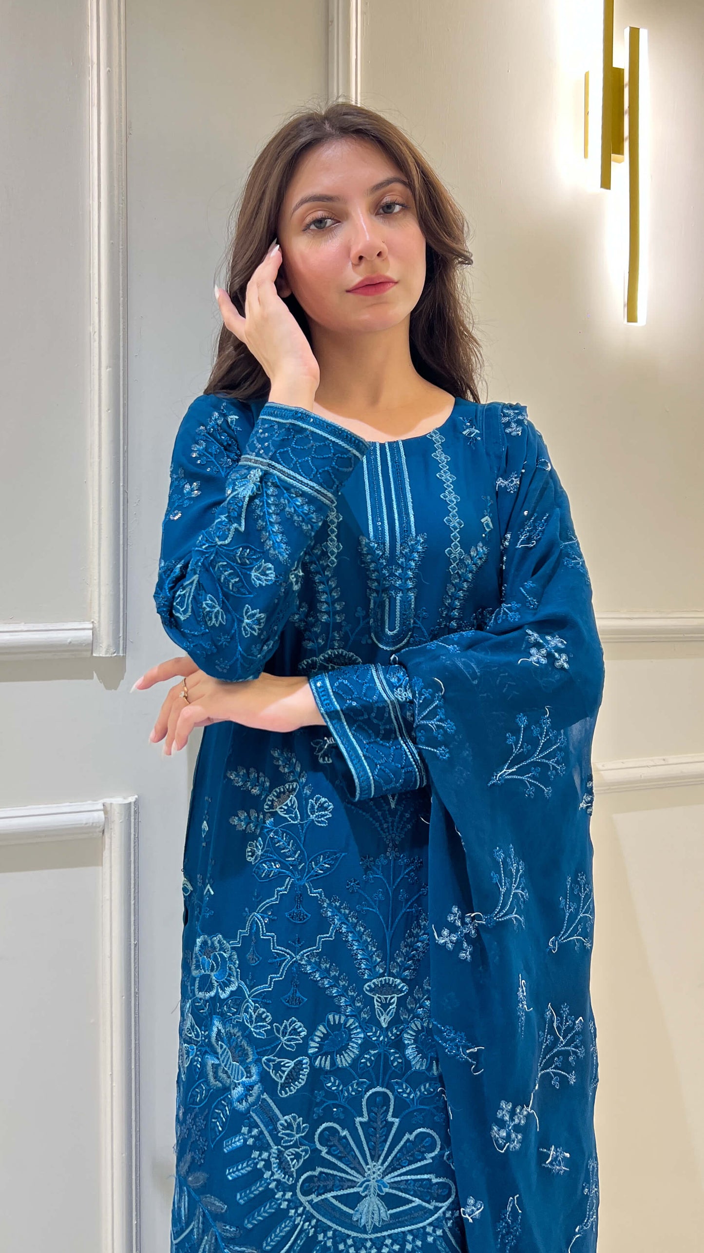 Close-up of embroidered peacock blue shirt and dupatta