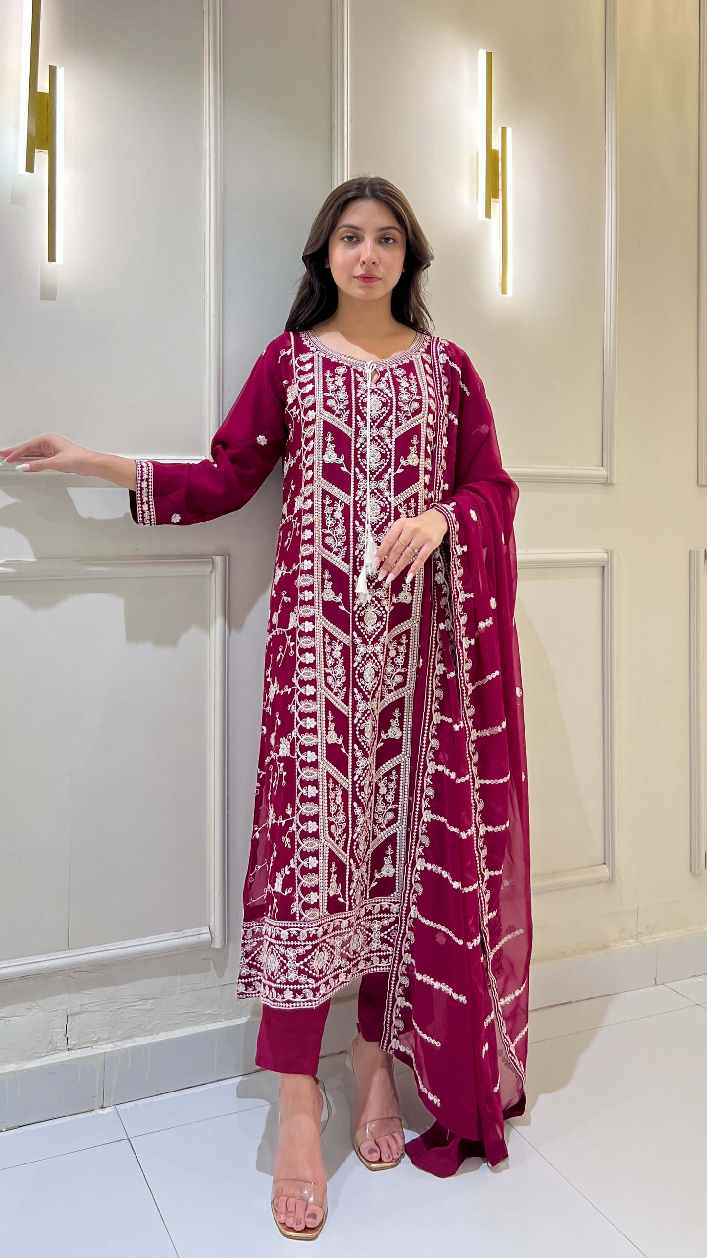 Woman styling embroidered magenta chiffon suit with embroidered dupatta
