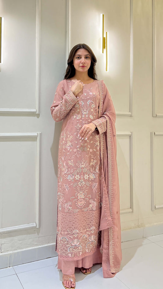 Woman posing in peach embroidered chiffon shalwar kameez