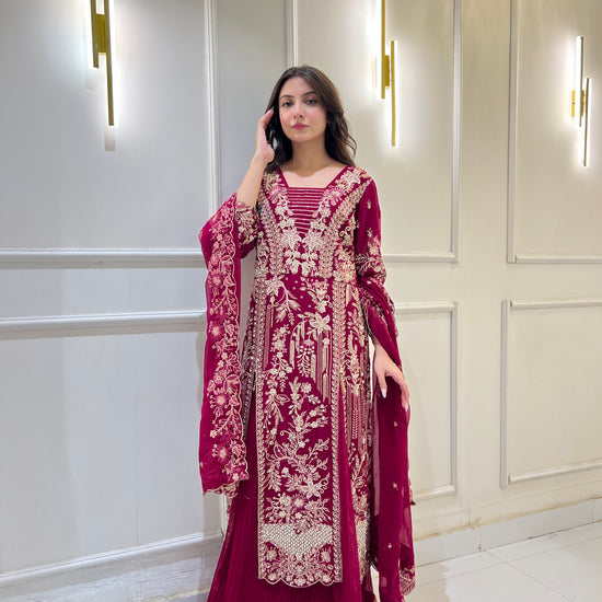 Model wearing magenta embroidered ijaar lehnga suit, twirling and walking to show fabric movement, embroidery details, and ijaar pant design.