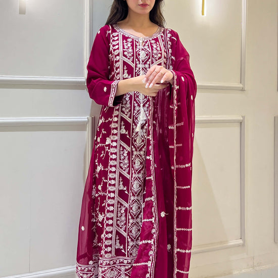 Woman posing in magenta chiffon suit with white embroidery details video