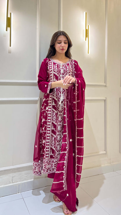 Woman posing in magenta chiffon suit with white embroidery details video