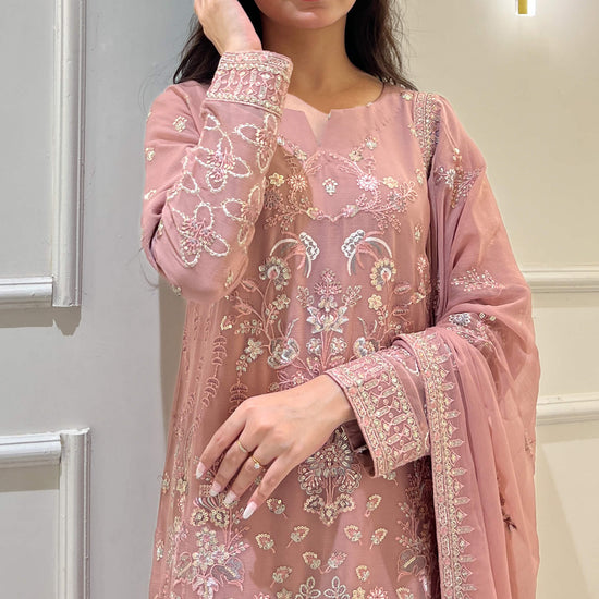Woman in peach embroidered chiffon shalwar kameez with matching dupatta Video