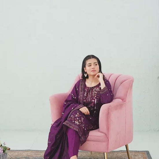 Model showcasing purple raw silk embroidered shalwar kameez set with elegant poses, embroidery highlights, and flowing dupatta styling.